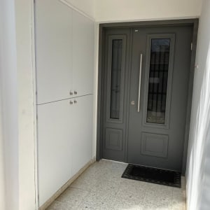 דלת אפורה עם ידית ארוכה וארון לבן