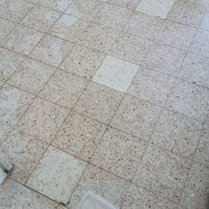 רצפה עם אריחים חסרים ועבודת תיקון