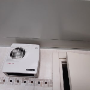 מאוורר קיר לבן מותקן על קיר גבס