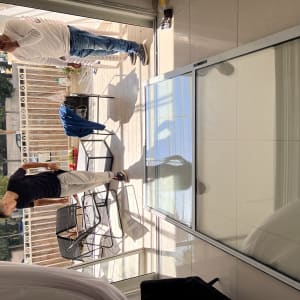 Large glass shutter lying on the floor with two people nearby.