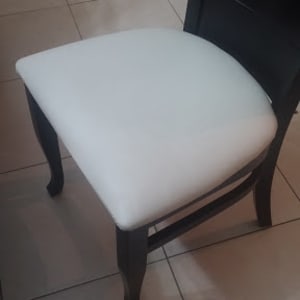 כיסא עם ריפוד לבן על מושב עץ כהה