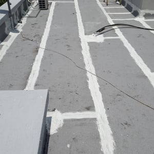 קווים לבנים של איטום על גג בטון אפור