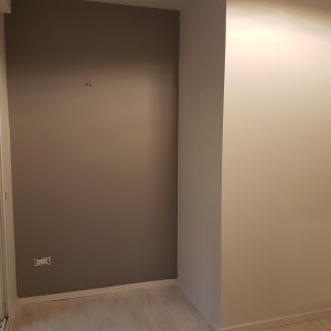 קיר צבוע בגוון חום בהיר עם שקע חשמל