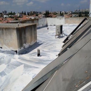 גג אטום בחומר לבן עם צינורות ומזגן