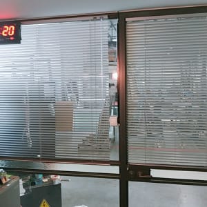 תריסים אופקיים על חלון זכוכית במשרד