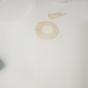 plastic ring and tape on white surface