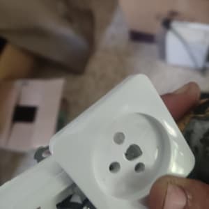 שקע חשמלי לבן מוחזק ביד של חשמלאי