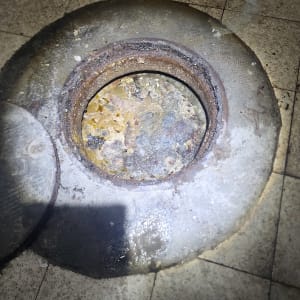 פתח ביוב עם לכלוך ופסולת