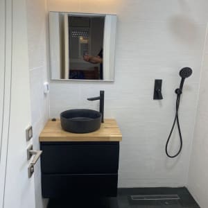 חדר אמבטיה עם כיור שחור וברז מודרני