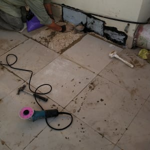 אדם עובד על איטום קיר עם חומרי בנייה