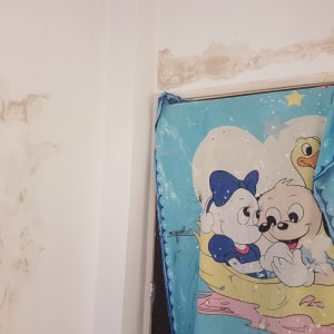 קיר עם תיקוני טיח וכתמי צבע