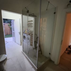 מקלחון זכוכית עם דלתות שקופות בחדר אמבטיה