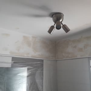 קיר עם טיח מתקלף ותאורה בתקרה