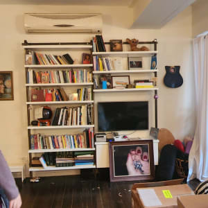 מדפים עם ספרים, קופסאות קרטון על הרצפה