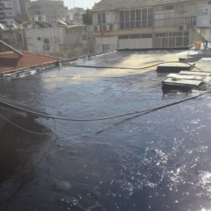 גג אטום בזפת שחורה עם כבלים