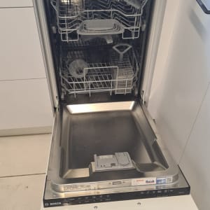 מדיח כלים פתוח עם כלים בפנים במטבח
