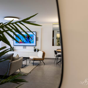 סלון מודרני עם ספה, כורסה ותמונה צבעונית על הקיר