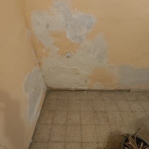 קיר עם קילופי צבע ותיקוני טיח