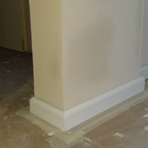 קיר צבוע עם פאנל לבן על רצפה מוכנה לצביעה