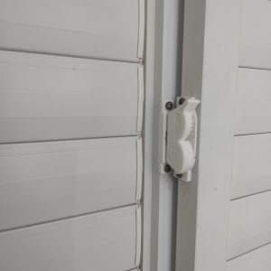 תריס גלילה לבן עם מנגנון פתיחה ידני