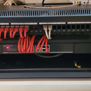 ארון תקשורת עם כבלים אדומים ומתג אתרנט