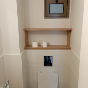 מדף עץ מעל אסלה עם נייר טואלט