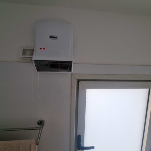 מאוורר חשמלי מותקן על קיר בחדר אמבטיה