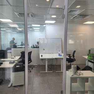 דלת זכוכית שקופה עם מסגרת מתכת במשרד מודרני