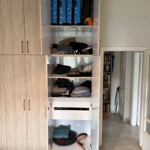 ארון עץ עם דלתות פתוחות ומדפים פנימיים