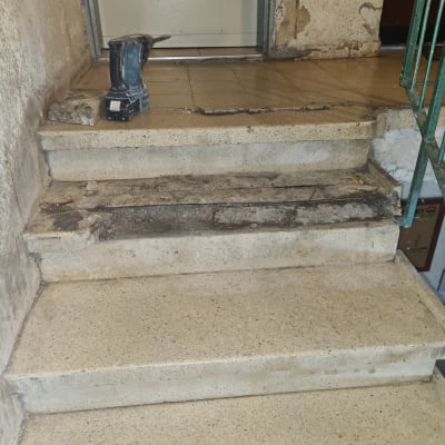 מדרגות מתפוררות עם כלי עבודה חשמלי על הרצפה