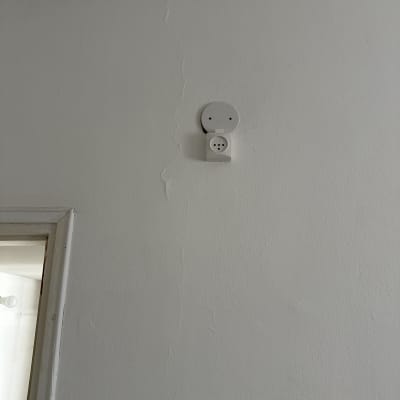 שקע חשמל עגול על קיר לבן