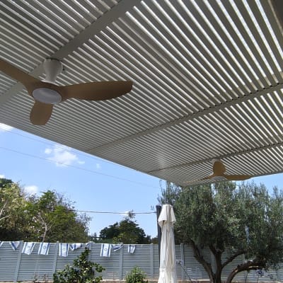 מאווררי תקרה מותקנים על פרגולה בחצר