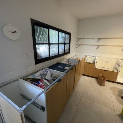 מטבח בבנייה עם ארונות פתוחים וכלים