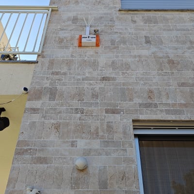 קופסת תקשורת כתומה מותקנת על קיר חיצוני