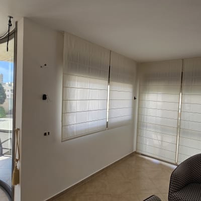 קירות ותקרה צבועים בלבן נקי בחדר מגורים מרוהט