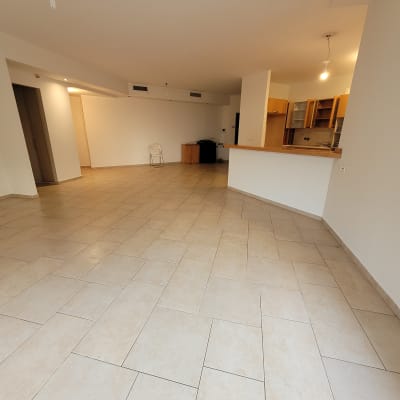 רצפה נקייה בחדר ריק עם מטבח פתוח