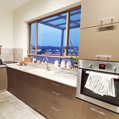 מטבח מאורגן עם תנור, כיור וכלי מטבח על השיש