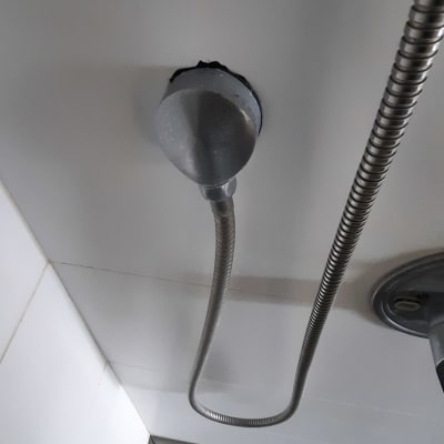 צינור מתכת מחובר לקיר בחדר אמבטיה