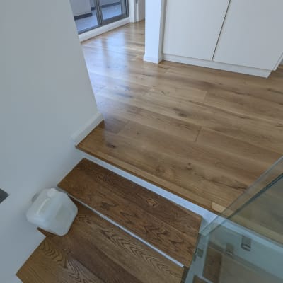 רצפת פרקט עץ עם מדרגות וחלון גדול