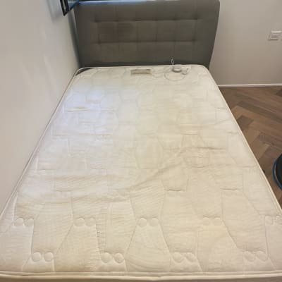 מיטה עם מזרן בחדר שינה ליד חלון פתוח