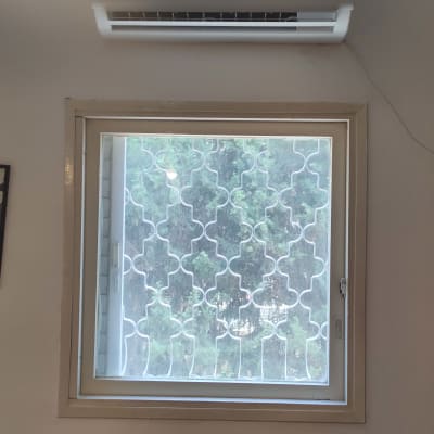 מזגן מותקן על קיר מעל חלון