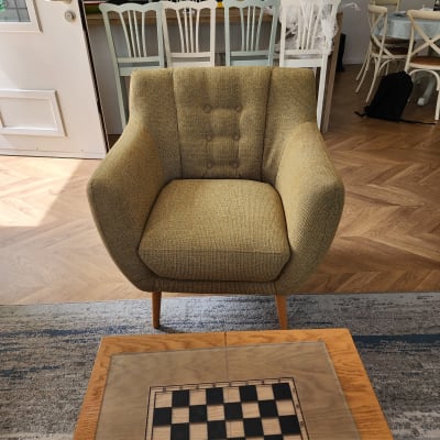 כורסה מרופדת בצבע חום בהיר עם כפתורים