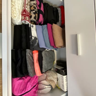 מגירת בגדים מסודרת עם בגדים מקופלים בצבעים שונים