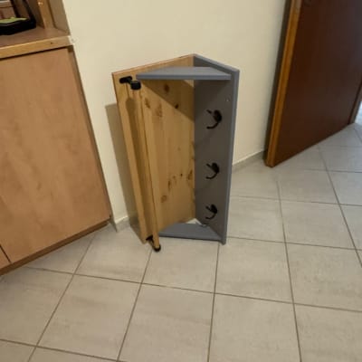 ארון עץ קטן על רצפת אריחים ליד דלת
