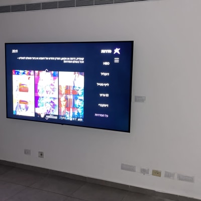 מסך טלוויזיה עם תפריט סדרות על קיר לבן