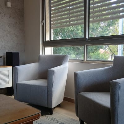 שתי כורסאות אפורות ליד חלון גדול בסלון מודרני