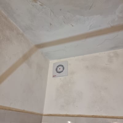 מאוורר מותקן על קיר בפינת חדר