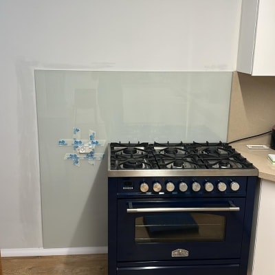 כיריים עם חיפוי זכוכית על הקיר מאחוריהם