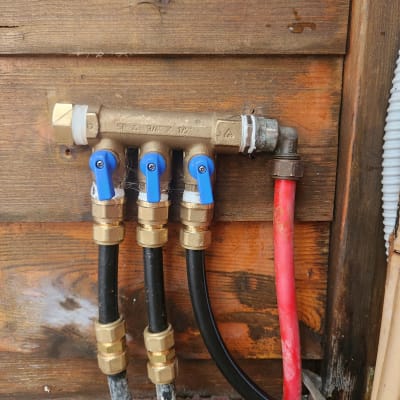 ברזים וצינורות מים מחוברים לקיר עץ