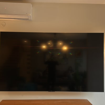 טלוויזיה תלויה על קיר עם תאורה משני הצדדים